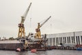 Cargo ship loading cranes in industrial zone on river, freight logistic transportation by water concept Royalty Free Stock Photo