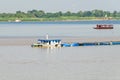 Cargo ship on the Mekong river in Cambodia, overloaded and low i Royalty Free Stock Photo