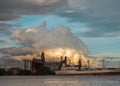 A cargo ship parked in front of Petroleum refinery on the Chao Phraya River in the evening Royalty Free Stock Photo