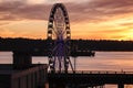 Cargo ship passing by Great Wheel at dusk.