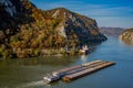 Cargo ship passing by Mraconia monastery on Romanian side of Danube river Djerdap gorge