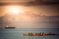 Cargo ship and rowing boats