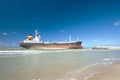 Cargo ship run aground on rocky shore Royalty Free Stock Photo