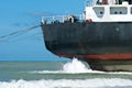 Cargo ship run aground on rocky shore Royalty Free Stock Photo