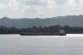 Cargo ship sailing through Gatun Lake, Panama Canal. Royalty Free Stock Photo