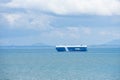 Cargo ship sailing through peaceful, calm, blue sea. Royalty Free Stock Photo