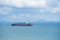 Cargo ship sailing through peaceful, calm, blue sea. Royalty Free Stock Photo