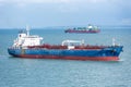 Cargo ship sailing through peaceful, calm, blue sea. Royalty Free Stock Photo