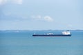 Cargo ship sailing through peaceful, calm, blue sea. Royalty Free Stock Photo
