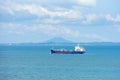 Cargo ship sailing through peaceful, calm, blue sea. Royalty Free Stock Photo