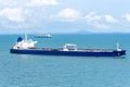 Cargo ship sailing through peaceful, calm, blue sea. Royalty Free Stock Photo