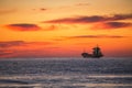 Cargo ship sailing on sunrise near the sea harbor