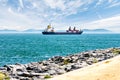 Cargo ship sails on a background of blue mountains Royalty Free Stock Photo