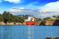 Cargo ship sails between the rocks of the Corinth Canal, Peloponnese, Greece Royalty Free Stock Photo