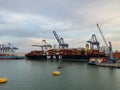 A cargo ship and shipping containers on a dock early in the morning at port in Cartagena, Columbia