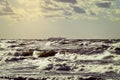 Cargo ship silhouette on the horizon. Large container vessel sailing through stormy waves of the Baltic Sea. Royalty Free Stock Photo