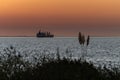 Cargo ship at sunset at Uruguay River, Colonia, Uruguay Royalty Free Stock Photo