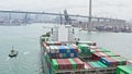 Cargo ship transporting shipment container to Hong Kong port, drone aerial view. Freight transportation, import export business