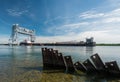 Cargo ship travelling under lift bridge Royalty Free Stock Photo