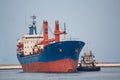 Cargo ship and tug boat Royalty Free Stock Photo