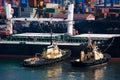 Cargo ship and tug boat in port Royalty Free Stock Photo