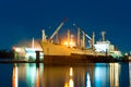 Cargo ship under repair in floating dry dock at night Royalty Free Stock Photo