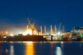 Cargo ship under repair in floating dry dock at night Royalty Free Stock Photo