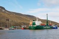 Cargo ship unloads at the harbor of Longyearbyen in Longyearbyen, Norway.