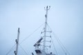 Cargo ship view of white top mast with lines and wires Royalty Free Stock Photo