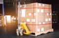 Cargo shipment boxes. Stacked of package boxes with hand pallet truck at the warehouse storage. Manufacturing and warehousing. Royalty Free Stock Photo