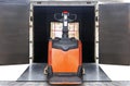 Cargo shipment loading for truck. Electric forklift pallet jack loading heavy cargo pallet into container truck. dock warehouse. Royalty Free Stock Photo