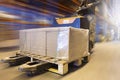 Cargo shipment, Warehousing storage. Motion speed blur of warehouse worker working with forklift pallet jack.