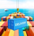 Cargo shipping container in blue with an inscription delivery loading concept the crane lifts the container on storage area Royalty Free Stock Photo