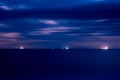 Cargo ships moored near the Pacific ocean coast at night