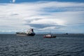 Cargo ships in Port Angeles Harbor, Washington under summer afternoon cloudscape