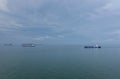 Cargo ships sailing through the cam, blue sea. Royalty Free Stock Photo