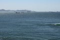 Cargo ships in storming sea at anchor. Sunny windy day. Royalty Free Stock Photo