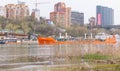 A cargo tanker is sailing along the river, past a modern metropolis Royalty Free Stock Photo