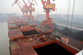 Cargo terminal for discharging coal cargos by shore cranes during foggy weather. Port Bayuquan,China. Royalty Free Stock Photo
