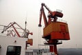 Cargo terminal for discharging coal cargos by shore cranes during foggy weather. Port Bayuquan,China. Royalty Free Stock Photo