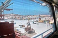 Cargo terminal for loading of gypsum cargo by ship cranes to bulk carrier. Port of Salalah, Oman.