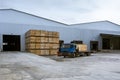 Cargo terminal of the logistics center. The truck in which the boxes are loaded. Stacked up empty pallets boxes. Ramp for loading