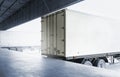 Cargo Trailer Truck Parked Loading at Dock Warehouse. Cargo Shipment. Industry Freight Truck Transportation. Royalty Free Stock Photo