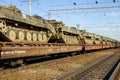 Cargo train carrying military tanks on railway flat wagons Royalty Free Stock Photo