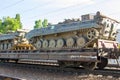 Cargo train carrying military tanks on railway flat wagons