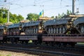 Cargo train carrying military tanks on railway flat wagons