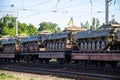 Cargo train carrying military tanks on railway flat wagons Royalty Free Stock Photo