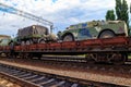 Cargo train carrying military vehicles on railway flat wagons