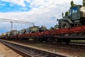 Cargo train carrying military vehicles on railway flat wagons