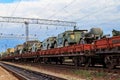 Cargo train carrying military vehicles on railway flat wagons